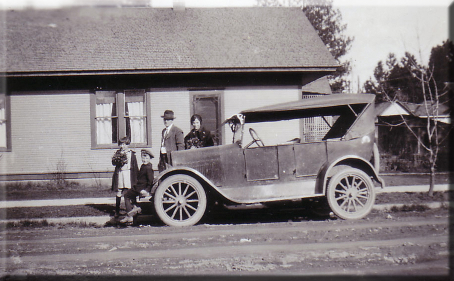 Family and automobile circa 1923