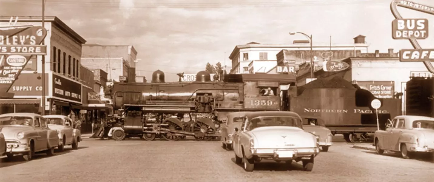 Cars waiting for a train to pass circa 1954