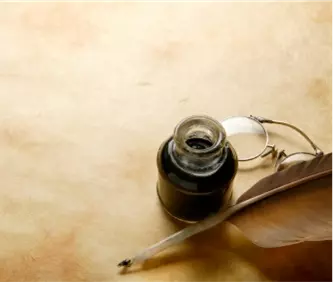 Old parchment paper with inkwell, feather pen, and round glasses.
