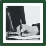 Hand with a pen writing.