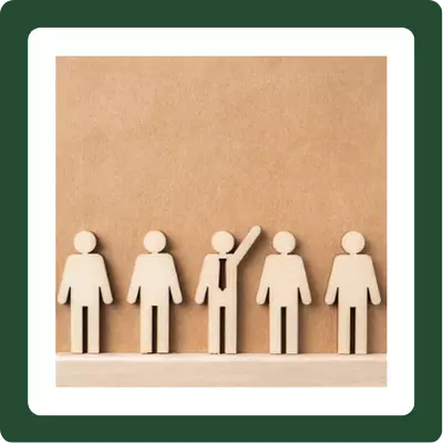 icon wood figures with middle figure raising hand and wearing a tie